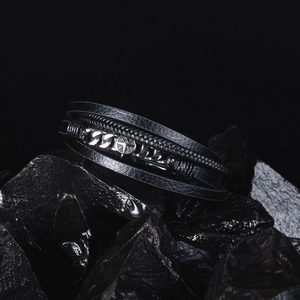 Macro shot of men's multi-layer woven leather bracelet with stainless steel compass star