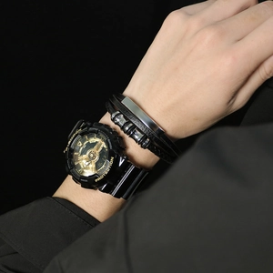 Close-up of a punk-style woven leather bracelet paired with a digital watch for men