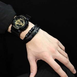 Men's sport watch with magnetic leather bracelets and woven wristbands on a dark wrist