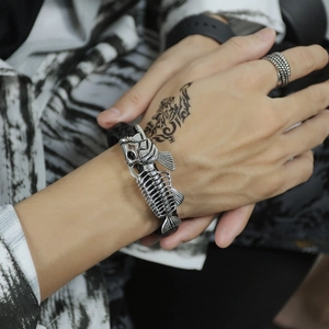 Men's hip hop stainless steel fishbone skeleton leather bracelet shown on wrist