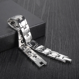 Men's silver magnetic health bracelet in polished stainless steel on a black gift box
