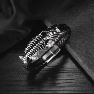 Detail of men's leather bracelet with silver fishbone charm and magnetic clasp