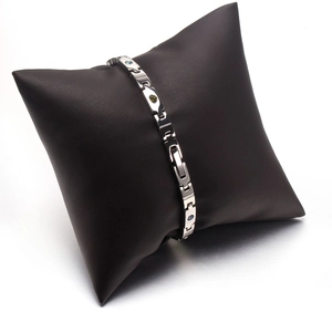 Close-up of titanium steel magnetic bracelet with colorful crystals on a black pillow