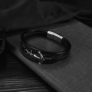 Detail of multi-layer leather bracelet for men with silver anchor charm and magnetic clasp