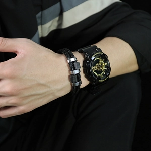 Close-up of black braided leather bracelet with textured stainless steel beads for men
