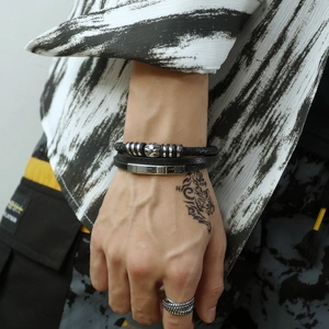 Men's multi-layer leather bracelet set with silver skull accents and vintage rings