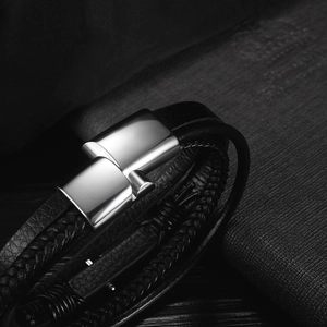 Detail of multi-layer black braided leather bracelet with magnetic stainless steel clasp