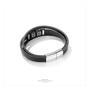 Close-up of multilayer black leather bracelet for men with polished magnetic steel clasp