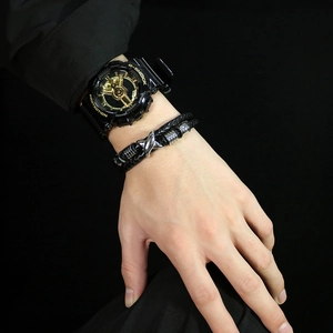 Close-up of double-layered black woven leather bracelet with stainless steel accents