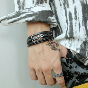 Men's multi-layer braided leather bracelet with silver anchor skull charm detail