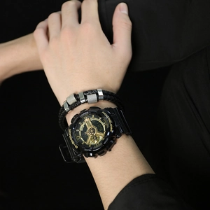 Close-up of a double-layered black leather bracelet with silver metal beads on a male wrist