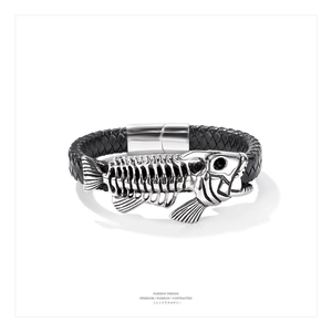 Close-up of men's black braided leather bracelet featuring a silver fishbone metal charm