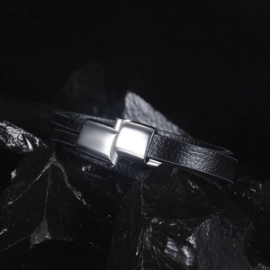 Close-up of double-layer black leather bracelet with polished silver metal clasp