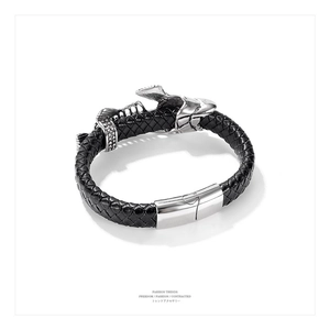Macro shot of men's black woven leather bracelet with polished silver magnetic clasp