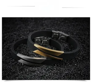 Detail of minimalist black silicone bracelets with brushed gold and silver stainless steel