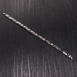 Titanium steel magnetic bracelet with colorful crystals on dark wood background