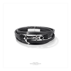 Detail of multi-layer leather bracelet with silver anchor pendant and magnetic clasp