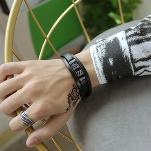Men's multilayer black braided leather bracelet with stainless steel spiral texture accent