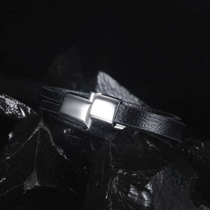 Detail of men's double-layer black braided leather bracelet with polished magnetic clasp