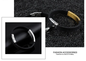 Close-up of minimalist men's silicone bracelets with gold and silver metal accents