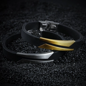 Macro shot of minimalist silicone bracelets with brushed gold and silver metal details