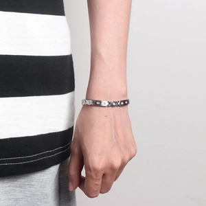 Detail of silver chain bracelet with round interlocking links and crystal zircon stones