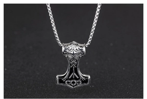 Macro view of Mjölnir pendant showing intricate Rune carvings and vintage metal details