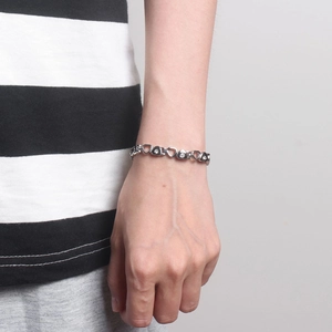Close-up of heart-shaped links with sparkling rhinestones on silver-tone bracelet
