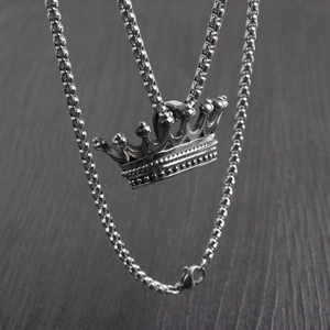 Detailed close-up of a hip hop style crown pendant necklace with sturdy box chain