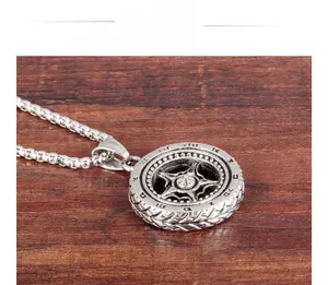Macro shot of punk style tire-shaped pendant with roman numerals and star spokes
