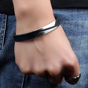 Minimalist men's leather bracelet with brushed metal accents worn on a model's wrist