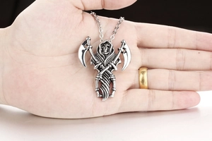 Detailed view of stainless steel grim reaper pendant with scythes held in hand