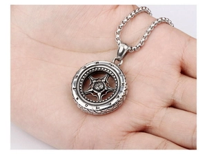 Close-up of vintage car wheel rim pendant with tire textures and round box chain