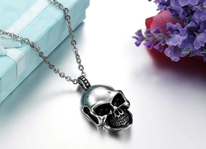 Detailed close-up of gothic skull pendant in silver steel with black oxidized accents