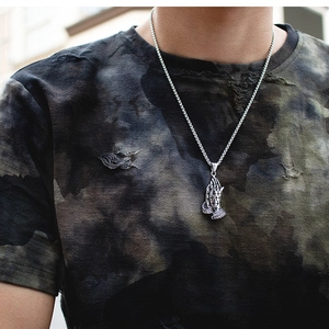 Détail du pendentif mains en prière en argent rétro avec texture croisée sur chaîne
