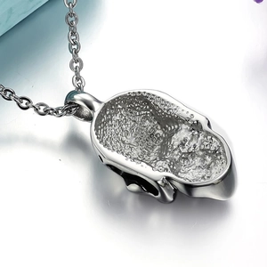 Men's cool skull pendant necklace in polished steel with textured hollow back detail