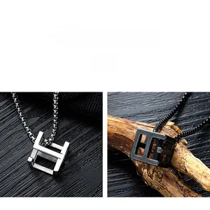 Detailed comparison of hollow cube pendants in silver and matte black stainless steel