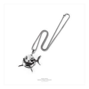 Macro view of silver stainless steel shark pendant with detailed teeth and punk chain