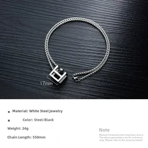 Detailed view of stainless steel cube pendant necklace with 550mm chain on wood surface