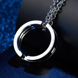 Macro detail of silver stainless steel ring pendant with FOREVER engraving on O-chain