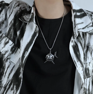 Gothic shark pendant necklace in silver stainless steel worn by a male model