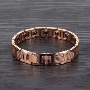 Detail of rose gold tungsten bracelet with grid texture and black magnetic therapy beads
