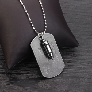 Close-up of vintage U.S. Army dog tag and bullet pendant on a steel ball chain