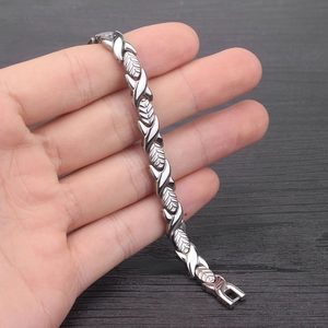 Silver stainless steel magnetic bracelet featuring polished X-shaped leaf design links