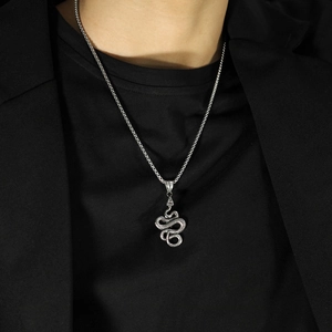 Detailed view of silver python snake pendant with scales on a thick steel chain