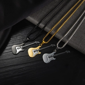 Detailed close-up of guitar pendant necklaces in black, gold, and silver stainless steel