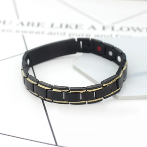 Men's magnetic therapy bracelet in matte black and gold with rectangular metal links