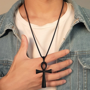 Detailed close-up of a matte black Ankh cross pendant on a matching beaded chain