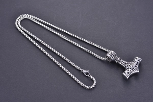 Detailed view of silver Viking Mjolnir pendant with intricate Celtic knot patterns