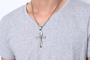 Polished silver Ankh cross pendant necklace displayed on a model wearing a grey t-shirt
